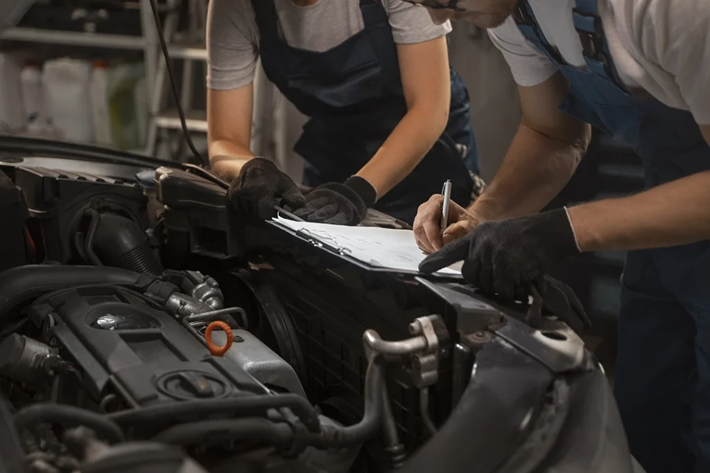 Two auto technicians performing a detailed ppi inspection in Lakes On Eldridge on a car engine