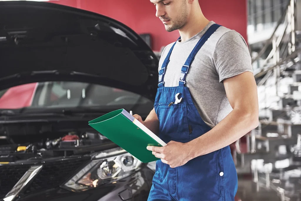 Mechanic holding clipboard during mobile pre-purchase inspection near The Villages Of Northpointe West.