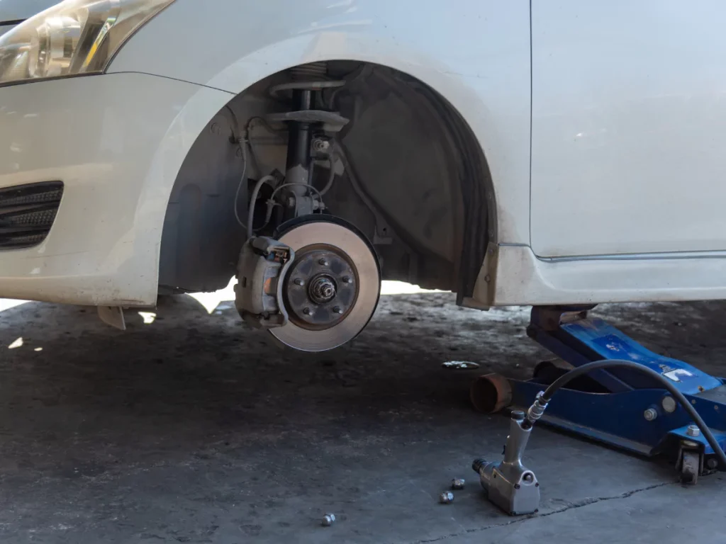 A car lifted for service, highlighting a comprehensive and reliable car inspection in Beltway Crossing Business Park.