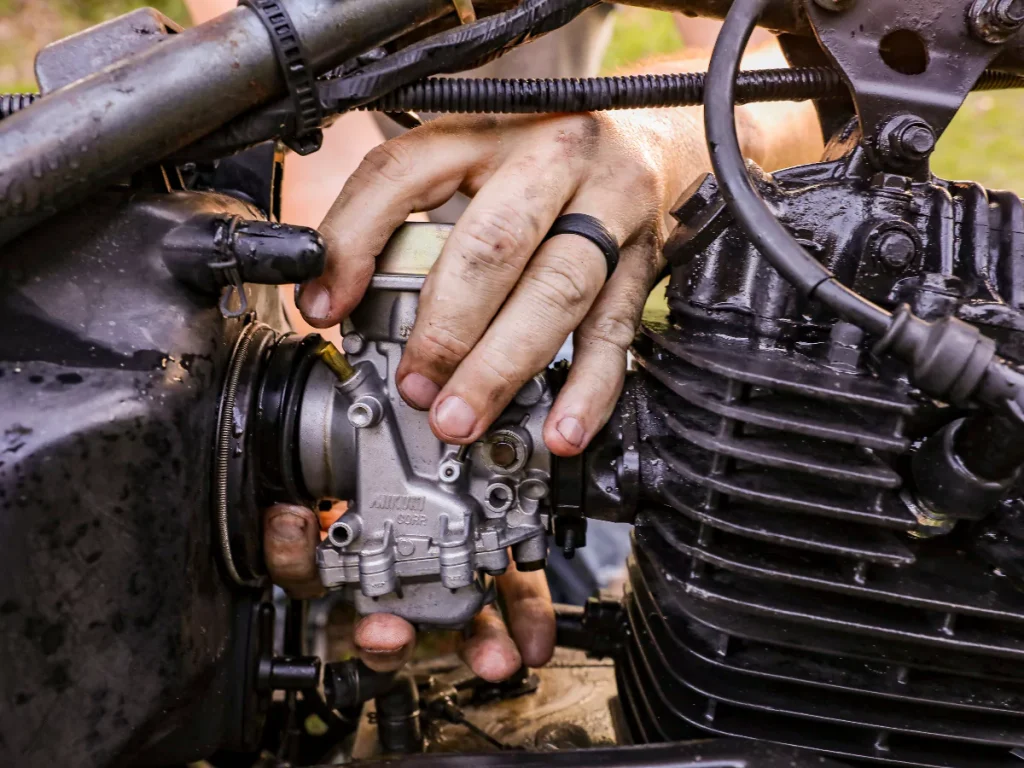 A technician from our reliable inspection services at Eldridge Meadow meticulously checking a bike's engine.