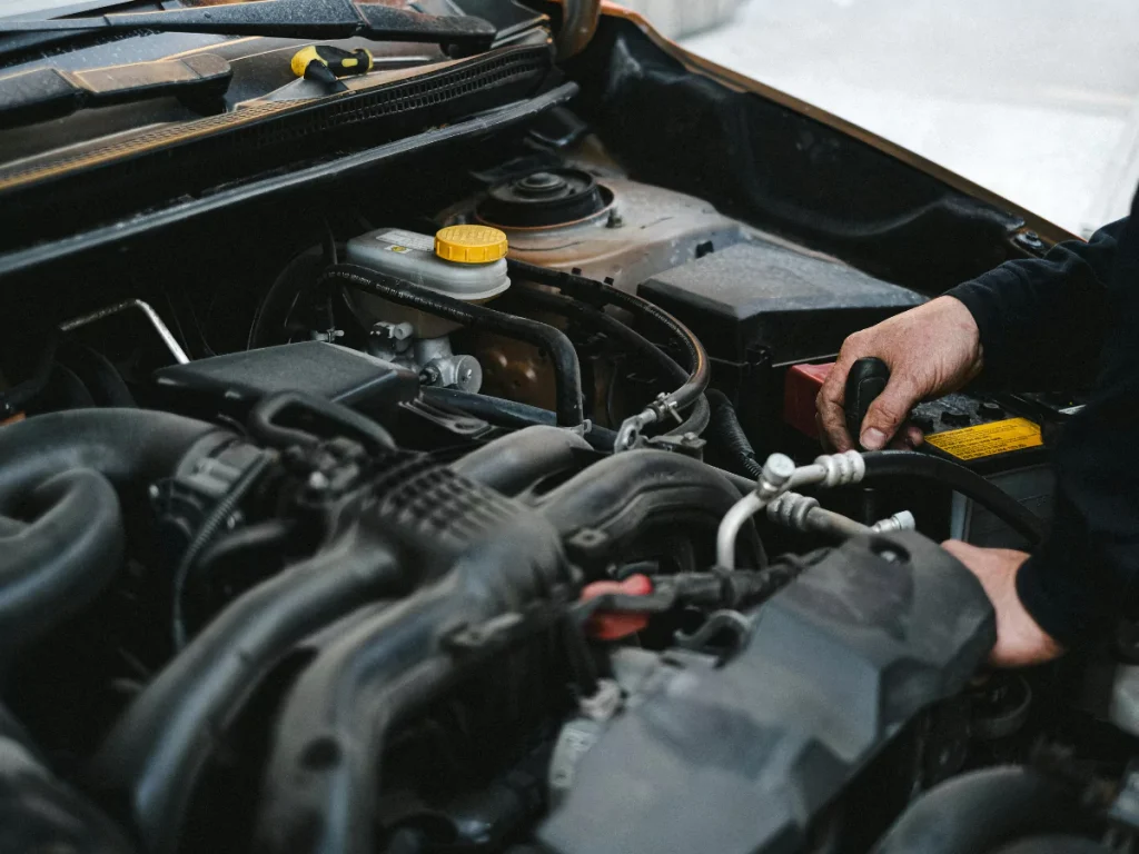 A certified mechanic performing a detailed engine bay check for a Westbranch used car inspection.