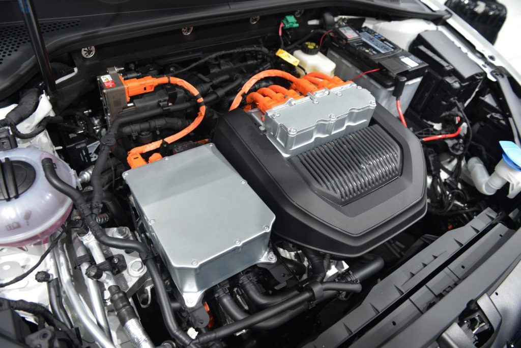 Close-up of electric car engine during used car inspection services in Houston.