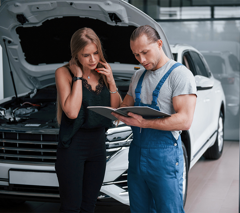 Technician explaining an affordable GMC pre-purchase inspection to a client in Houston.