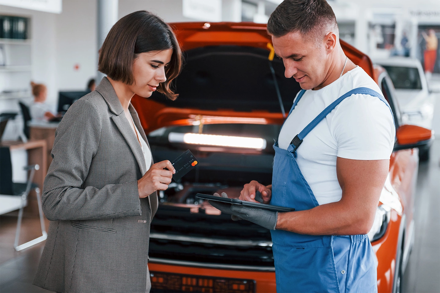 Technician explaining Tesla pre-purchase inspection details to a client in Houston