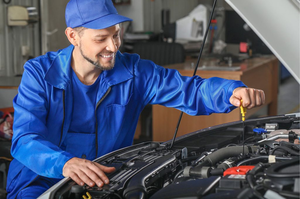 Expert mechanic checking oil levels during a thorough third party inspection Houston residents use for pre-purchase peace.