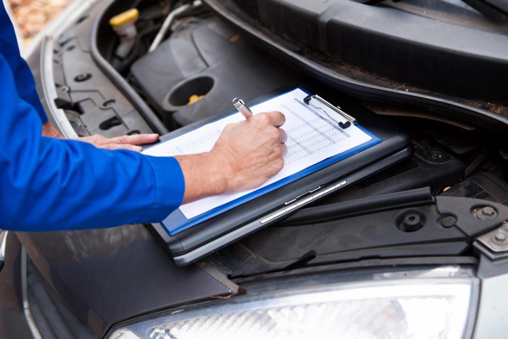 Certified technician performing a mobile car check Houston on a vehicle engine to ensure peak performance and safety.