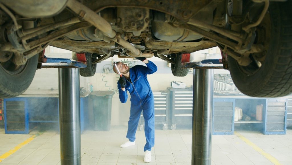 Detailed under-chassis vehicle check during a third party inspection Houston experts provide for used car evaluations.