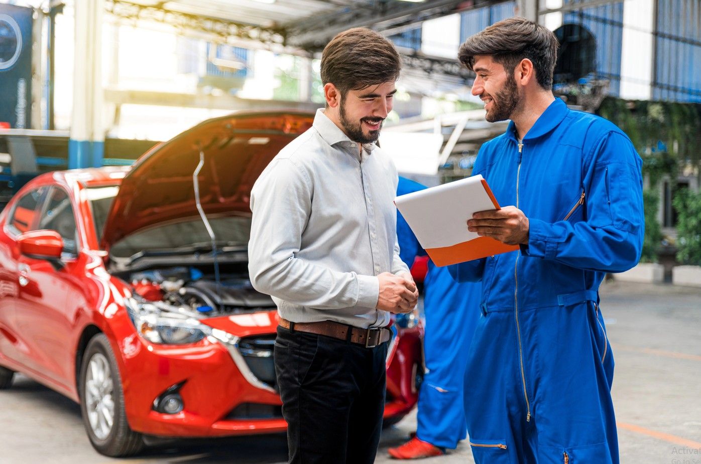 Used car inspection with report Houston — inspector reviewing findings with buyer after vehicle check