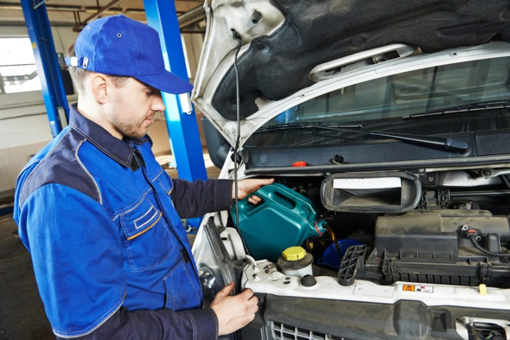 A certified mechanic performs routine oil service; verified by a detailed third party inspection Houston provider.