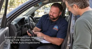 Trusted used car inspection mechanic using a scanner to run full diagnostics while explaining notes to a client.