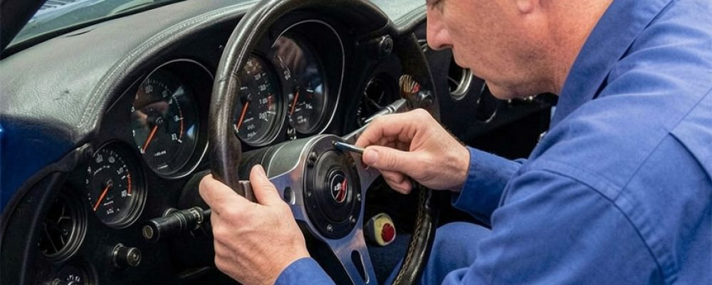 Expert mechanic using a digital scanner on the engine during a Corvette Pre Purchase Inspection Houston diagnostic.